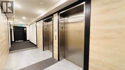 Hallway featuring elevator and marble finish flooring - 
