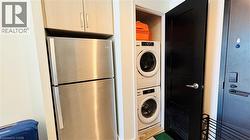 Washroom featuring stacked washer / drying machine - 
