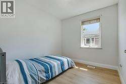 Bedroom featuring baseboards and light wood-type flooring - 
