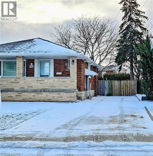 Snow covered property featuring brick siding - 111 Castlefield Drive, Hamilton, ON - Outdoor