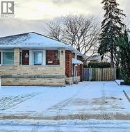Snow covered property featuring brick siding - 
