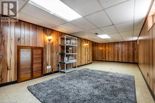 Finished below grade area featuring a drop ceiling and wood walls - 111 Castlefield Drive, Hamilton, ON - Indoor