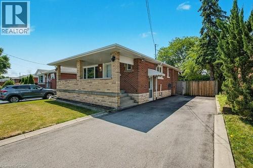 View of side of home featuring brick siding and driveway - 111 Castlefield Drive, Hamilton, ON - Outdoor
