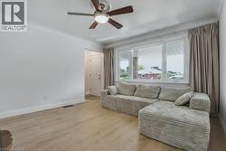 Living area featuring wood finished floors and ceiling fan - 