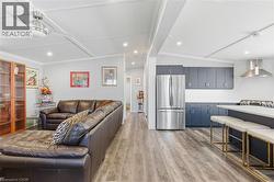 Living room with light wood-type flooring and recessed lighting - 