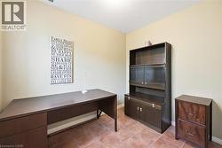 Office area featuring light tile patterned floors and baseboards - 