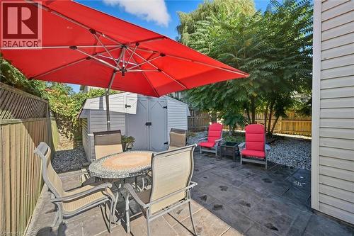 Fenced backyard featuring outdoor dining area, a patio area, and a storage shed - 21 Arden Avenue, Hamilton, ON - Outdoor With Deck Patio Veranda With Exterior