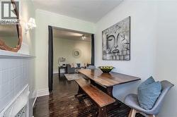 Dining space with crown molding and dark wood-style floors - 