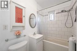 Bathroom featuring vanity and shower / bath combo with shower curtain - 