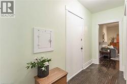 Hall featuring dark wood-style floors and baseboards - 
