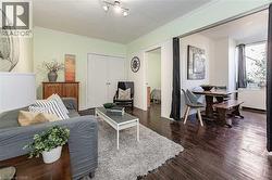 Living area featuring wood finished floors and ornamental molding - 