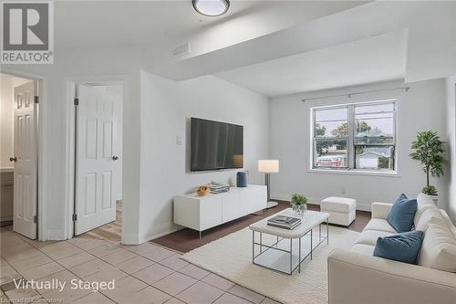 Living area featuring light tile patterned flooring and baseboards - 897 Barton Street E, Hamilton, ON - Indoor