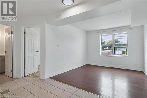 Spare room featuring light wood-style flooring and baseboards - 897 Barton Street E, Hamilton, ON - Indoor Photo Showing Other Room