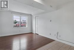 Unfurnished room featuring baseboards and wood finished floors - 