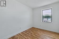 Spare room featuring light wood finished floors and baseboards - 