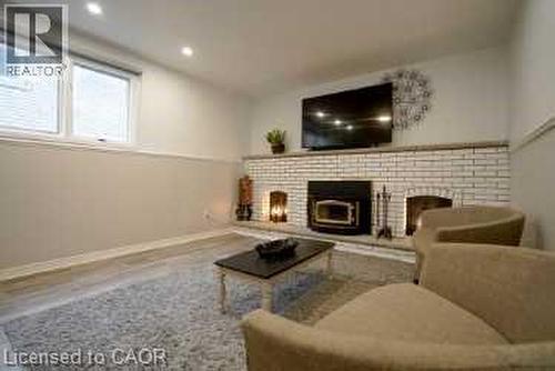 Living area featuring a fireplace, recessed lighting, and wood finished floors - 147 Muriel Crescent, London, ON - Indoor Photo Showing Living Room With Fireplace