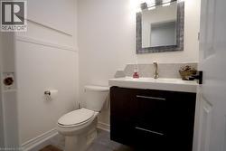 Bathroom with vanity and dark tile patterned floors - 