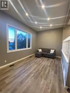 Living area with recessed lighting and wood finished floors - 