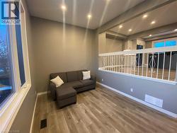 Living area with wood finished floors and recessed lighting - 