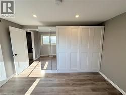 Unfurnished bedroom with light wood-style flooring, a closet, and recessed lighting - 
