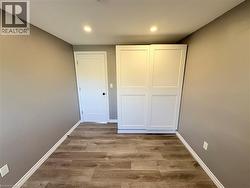 Unfurnished bedroom with light wood-style floors and recessed lighting - 
