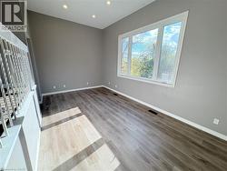 Unfurnished room with wood finished floors and recessed lighting - 
