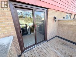 Entrance to property with a deck and brick siding - 