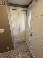 Doorway to outside featuring tile patterned floors - 