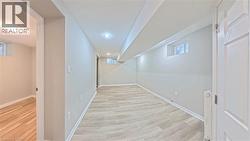 Basement featuring light wood finished floors - 