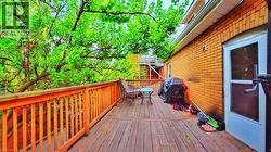 Wooden deck featuring a grill - 