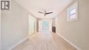 Empty room with a ceiling fan, light wood-style floors, and radiator - 25 Spadina Avenue, Hamilton, ON  - Indoor Photo Showing Other Room 