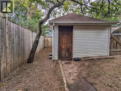 View of shed with a fenced backyard and a gate - 
