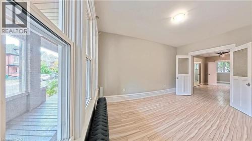 Empty room featuring light wood finished floors and a ceiling fan - 25 Spadina Avenue, Hamilton, ON - Indoor Photo Showing Other Room