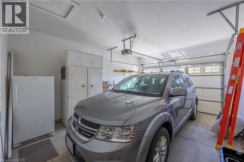 Large garage with room to spare. Auto garage door equipped. - 510 Queensway W Unit# 5, Simcoe, ON - Indoor Photo Showing Garage