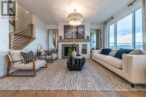 120 Southborough Common, Cochrane, AB - Indoor Photo Showing Living Room With Fireplace
