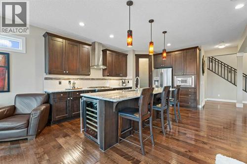 Modern kitchen with sleek finishes, ample storage, and a large island, perfect for cooking, entertaining, or gathering with family - 199 Cranarch Landing Se, Calgary, AB - Indoor Photo Showing Kitchen With Upgraded Kitchen