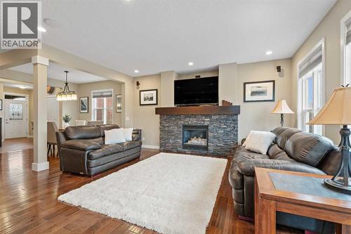 Grab your popcorn and have a movie night - 199 Cranarch Landing Se, Calgary, AB - Indoor Photo Showing Living Room With Fireplace