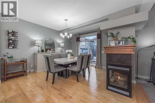 76 Evanspark Circle Nw, Calgary, AB - Indoor Photo Showing Dining Room With Fireplace