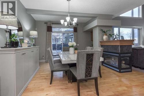 76 Evanspark Circle Nw, Calgary, AB - Indoor Photo Showing Dining Room With Fireplace