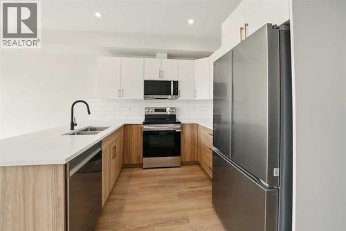 57 Pinnacle Close, Blackfalds, AB - Indoor Photo Showing Kitchen With Double Sink With Upgraded Kitchen