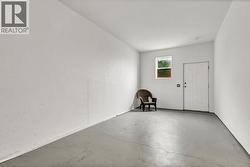 Suite entrance within an enclosed carport for extra storage or space - 