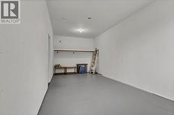 Suite entrance within an enclosed carport for extra storage or space - 