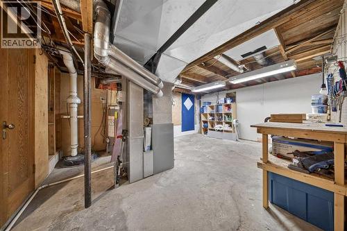 High Eff Furnace and updated Hot Water Tank - 414 12 Avenue Nw, Calgary, AB - Indoor Photo Showing Basement