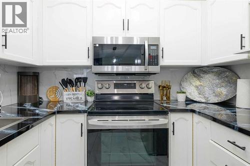 13 Mt. Aberdeen Manor Se, Calgary, AB - Indoor Photo Showing Kitchen With Double Sink