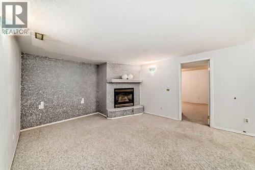 352 Malvern Close Ne, Calgary, AB - Indoor Photo Showing Living Room With Fireplace