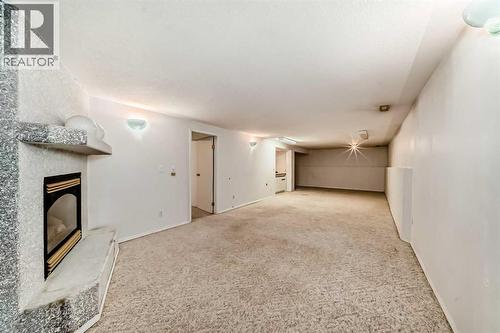 352 Malvern Close Ne, Calgary, AB - Indoor Photo Showing Other Room With Fireplace
