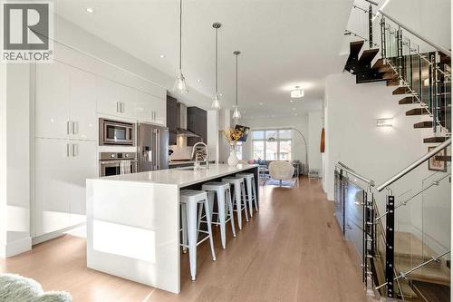 Large Island W/ Waterfall Quartz Countertop - 303 30 Avenue Ne, Calgary, AB - Indoor Photo Showing Kitchen With Upgraded Kitchen