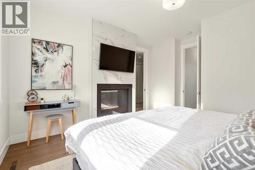 See Through Gas Fireplace from the Bedroom to the 5 Piece Ensuite Bathroom - 303 30 Avenue Ne, Calgary, AB - Indoor Photo Showing Bedroom