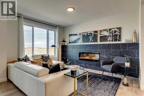 149 Southbow Drive, Cochrane, AB - Indoor Photo Showing Living Room With Fireplace