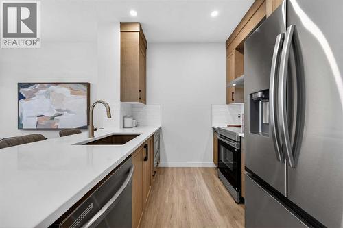 1051 Bayview Crescent, Airdrie, AB - Indoor Photo Showing Kitchen With Stainless Steel Kitchen With Upgraded Kitchen